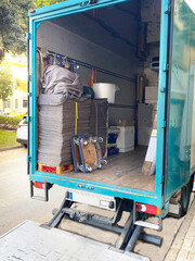 moving truck parked ready to load, with the truck doors open and empty boxes ready to fill.