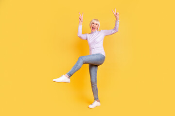 Fototapeta na wymiar Full body profile side photo of senior woman show fingers peace cool v-symbol isolated over yellow color background