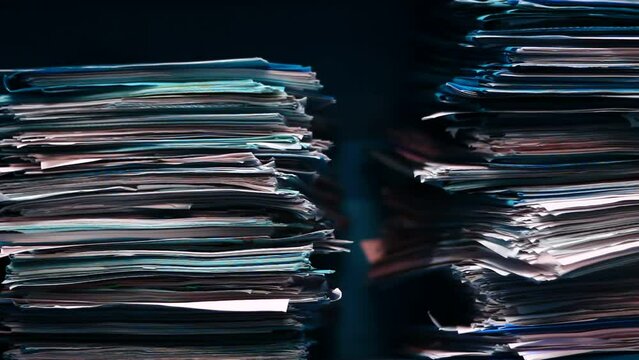 Old papers in the archive in a big stack.