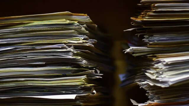 Old papers in the archive in a big stack.