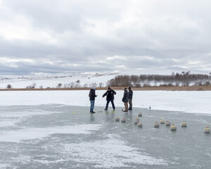 Winter ice games on frozen lake