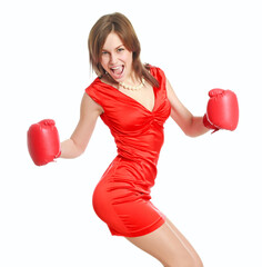 Expressive and emotional young woman in red dress and boxing gloves poses joyfully, isolate on white background, concept of beauty and power of femininity