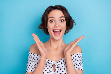 Photo of impressed cheerful girl raise hands open mouth cant believe news isolated on blue color...