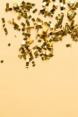 Gold sparkles particles on beige background. Holiday, wedding , cosmetic  backdrop. Copy space