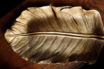 Plate in the form of a leaf, gold color