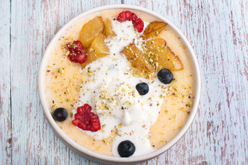 Semolina porridge with raspberry, blueberry and pear ice cream