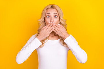 Photo of pretty impressed lady dressed white shirt arms cover lips big eyes isolated yellow color background