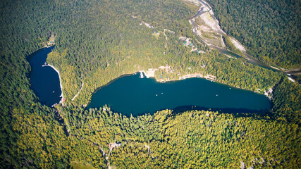 Lakes surrounded by autumn forest from the air. - obrazy, fototapety, plakaty