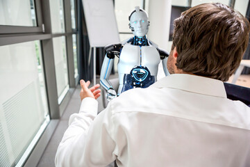 Businessman and humanoid robot solving problems