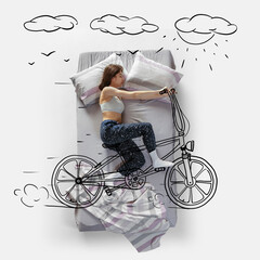 Creative image. Top view of young woman lying on bed, sleeping, dreaming about riding bike