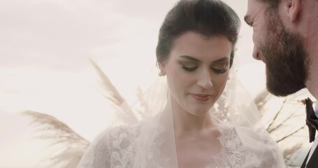 Groom puts marriage ring on bride finger at wedding ceremony