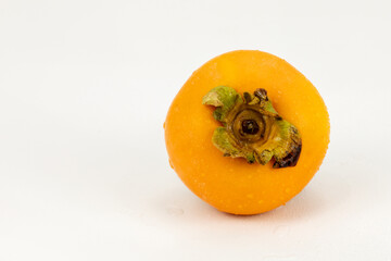 Persimmon single - Fresh Kaka fruit isolated in extendable white background with shadow and water drops, crystal clear and macro details, shot using studio lights and macro lens.