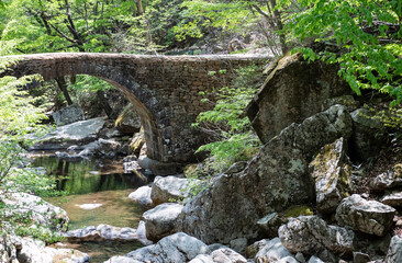stone bridge in a valley in the mountains