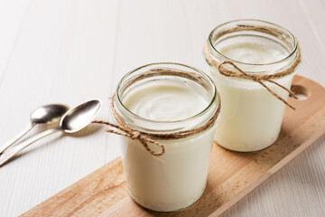 Homemade Greek yogurt in a glass jars ready to eat. Healthy breakfast.