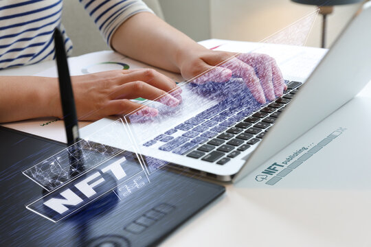 Woman issuing NFT at desk with laptop and tablet (holographic effect)