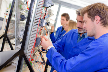 Teacher helping student with wiring