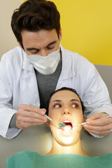 Fototapeta dentist using a dentist mirror on patient mouth obraz
