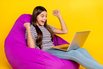 Profile side photo of young excited girl celebrate success fists hands lucky triumph isolated over yellow color background