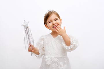 portrait of little smiling blonde girl princess, fairy tale fairy with magic wand in hand and crown...