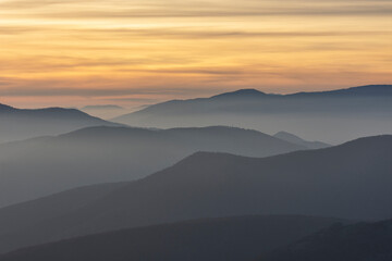 Stunning sunset over foggy Old mountain, Bulgaria. Landscape, travel concept.