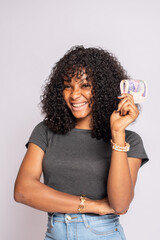 excited young african woman holding some money in mint