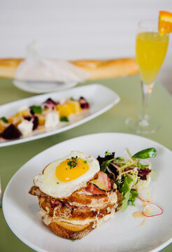 Croque Madame (toast topped with dry-cured ham, grilled cheese and a fried egg)