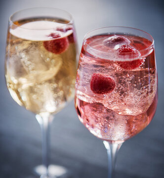 Two summer wine cocktails with raspberries