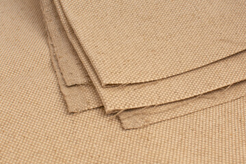 samples of curtain or drapery fabric. production of upholstered for furniture furnishing, details. Beige fabric samples swatch.