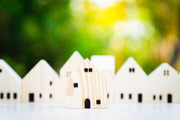 House model on wood table. Real estate agent offer house, property insurance and security,...