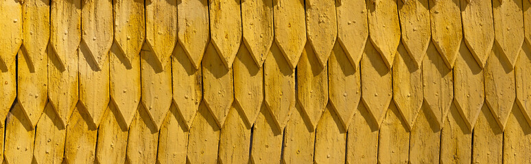 Yellow wooden roof at daytime outdoors, banner.