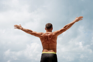 Athletic man warming up and stretching. Outdoor workout