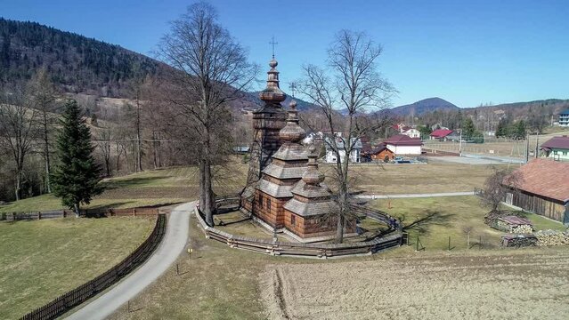 St. Paraskevi wooden church in Kwiatoń, Poland.  Built in 17th century. Originally an eastern orthodox church (tserkov), now a Roman Catholic church. UNESCO World Heritage Site. Aerial 4K video