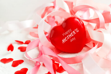 Happy Mother's Day or Happy women's day. Valentine's day. Red heart on the background of blurred holiday ribbons on white background. Banner for store. Greeting card.