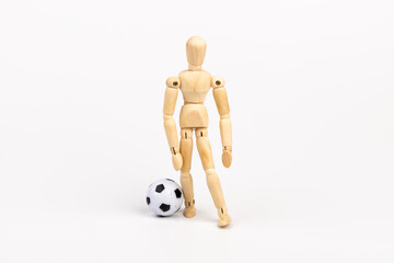 Wooden mannequin with soccer ball isolated on white background. Football player concept.