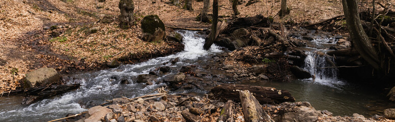 Mountain river and stones in forest in autumn, banner.