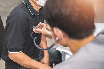Doctor using a stethoscope checking patient and listen to the heartbeat patient.presenting results symptom and recommend treatment method, Healthcare and medical concept.	