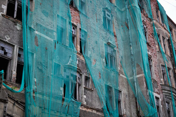 Fototapeta na wymiar reconstruction of the facade of an abandoned brick building in Vyborg