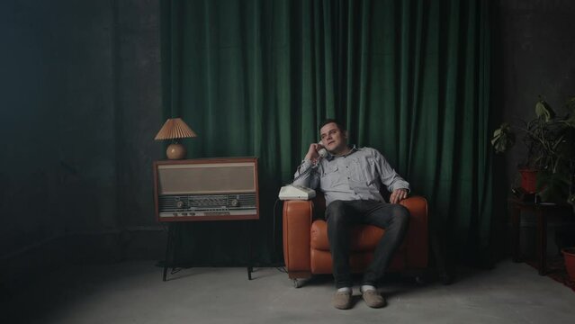 Special secret agent speaking by old landline phone in retro room. Spying or intelligence gathering. Espionage concept. Report information to superiors.