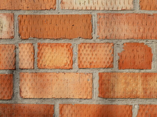 Red brick wall background with close-up texture. The texture of the red brick wall. Orange brick...