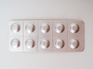 Pills in a grey blister pack. Close-up