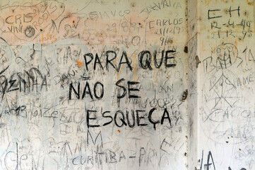 Ruins and graffiti wall with a "Not to Forget" message in Prison Island (Ilha do Presidio), Porto Alegre, Rio Grande do Sul, Brazil