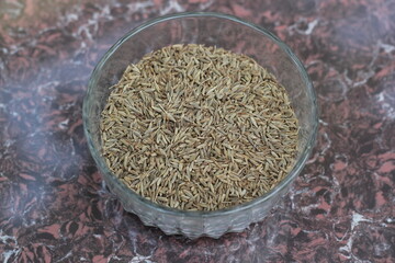 Dried cumin seeds decorated on a glass bowl