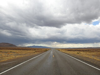 Storm clouds looming over the remote desert, above State Highway 266.  A desolate route of vast wilderness that takes you across the Nevada - California Border. 
