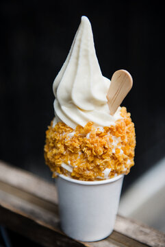 Vanilla ice cream topped with cereal.