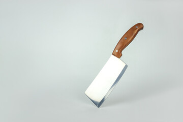 Big kitchen knife balanced on its end. Creative layout. Chef, restaurant or kitchen concept.