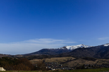 Landscape with mountains and blue sky at background.