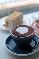 Coffee and cake with foam in a mug