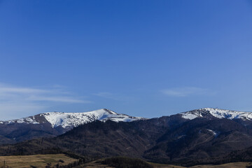 Mountains with snow and blue sky at daylight.