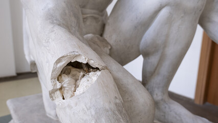 damaged statue, statue with broken arm