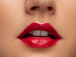Fototapeta premium Perfect red lips makeup. Close up macro photo with beautiful female mouth. Plump full lips. Close-up face detail. Perfect clean skin, light fresh lip make-up. Beautiful spa tender lip
